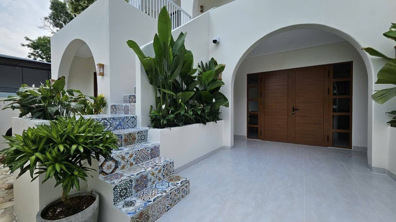 Charming entrance framed by tropical plants