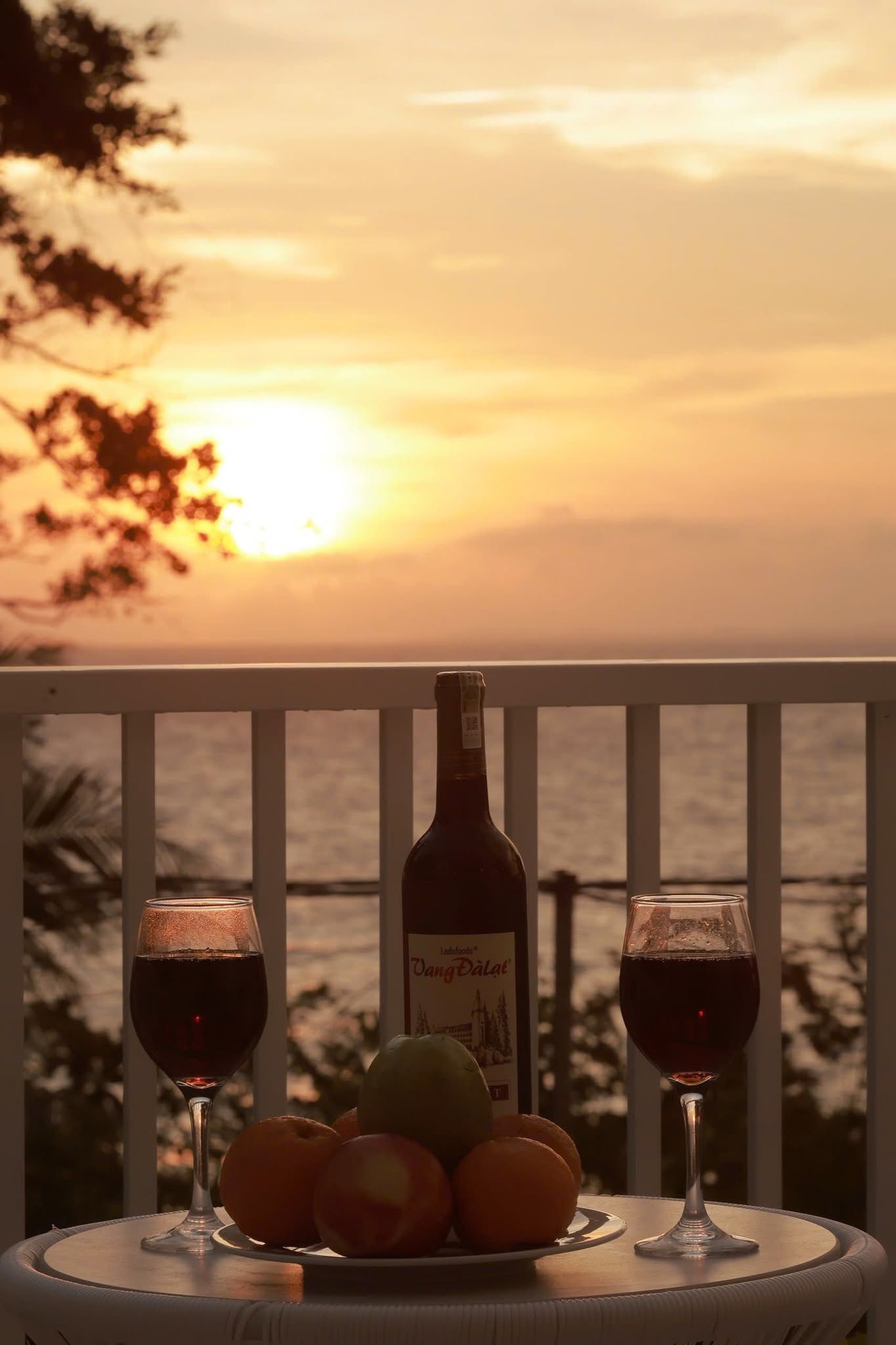 Romantic sunset with wine and fruit on the sea-view balcony